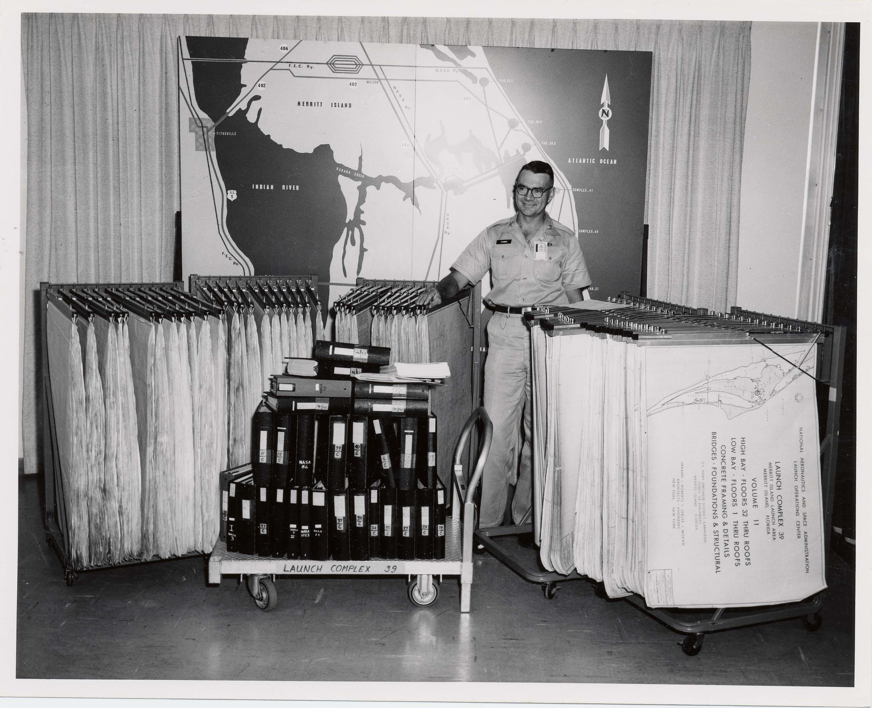 Corps Officers with racks of paper plans Corps Officers with racks of paper plans